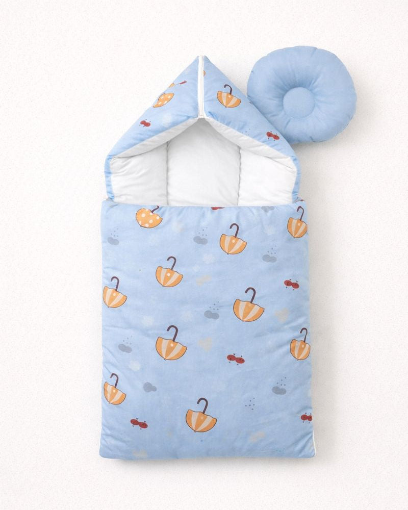 Blue baby sleeping bag with umbrella pattern on a white background